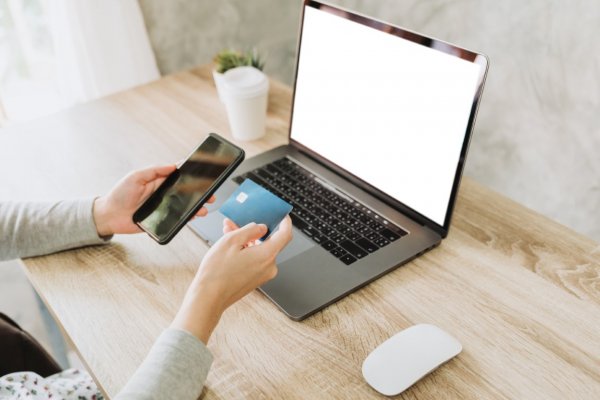 person checking phone and laptop